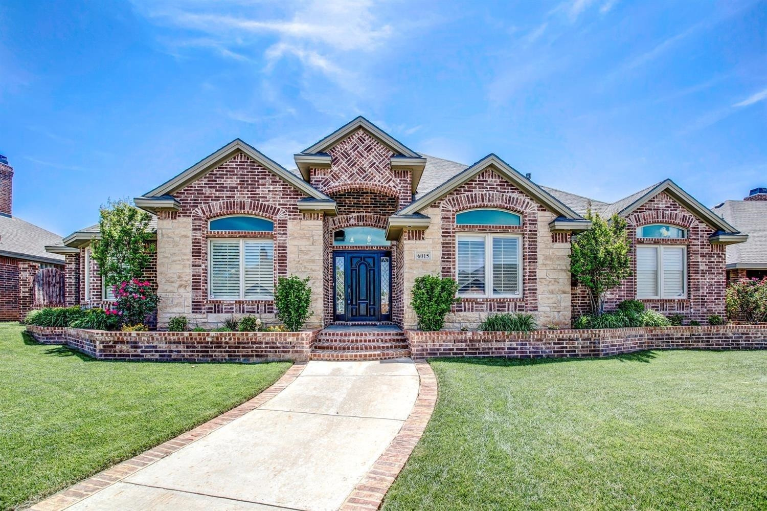 6015 85th Street Lubbock, TX 79424 - Photo 1 of 26 a front view of a house with a yard