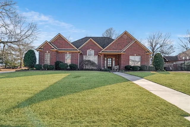a front view of house with yard and green space