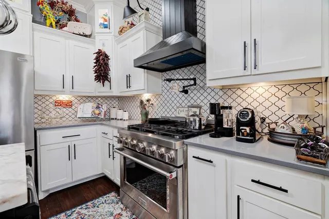 a kitchen with a stove and cabinets