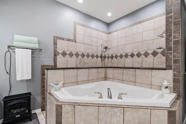 a bathroom with a bathtub and shower