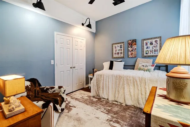 a bedroom with a bed and wooden floor