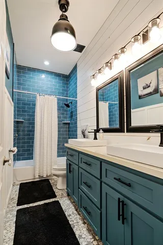 a bathroom with a double vanity sink and a mirror