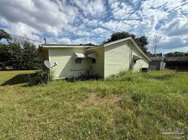 a backyard of a house with lots of green space