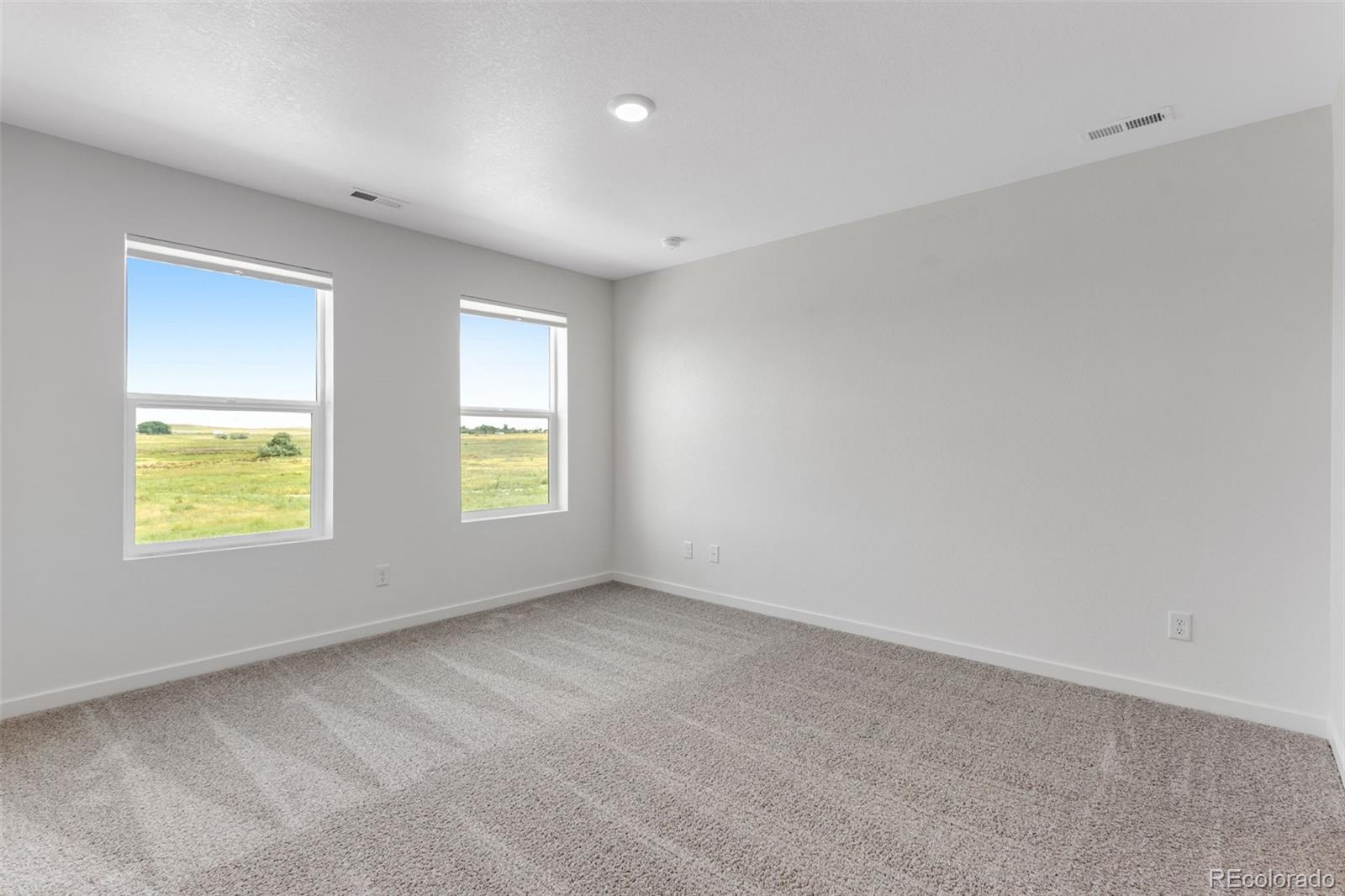 2403 Pinot Place Fort Lupton, CO 80621 - Photo 11 of 20 a view of an empty room with a window