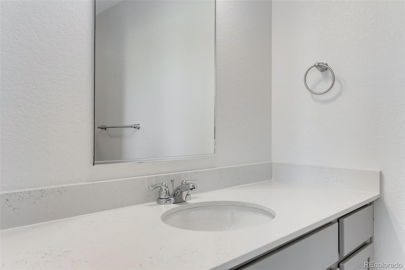 2403 Pinot Place Fort Lupton, CO 80621 - Photo 13 of 20 a bathroom with a sink and a mirror