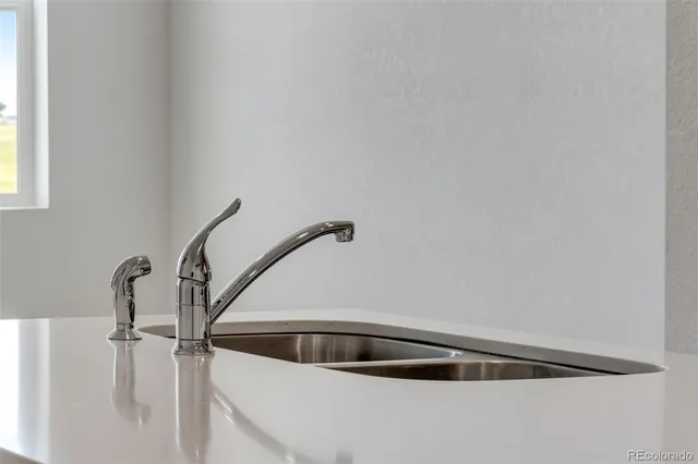 a kitchen with a sink and refrigerator
