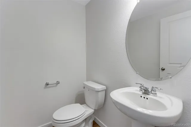 a white toilet sitting next to a bathroom sink