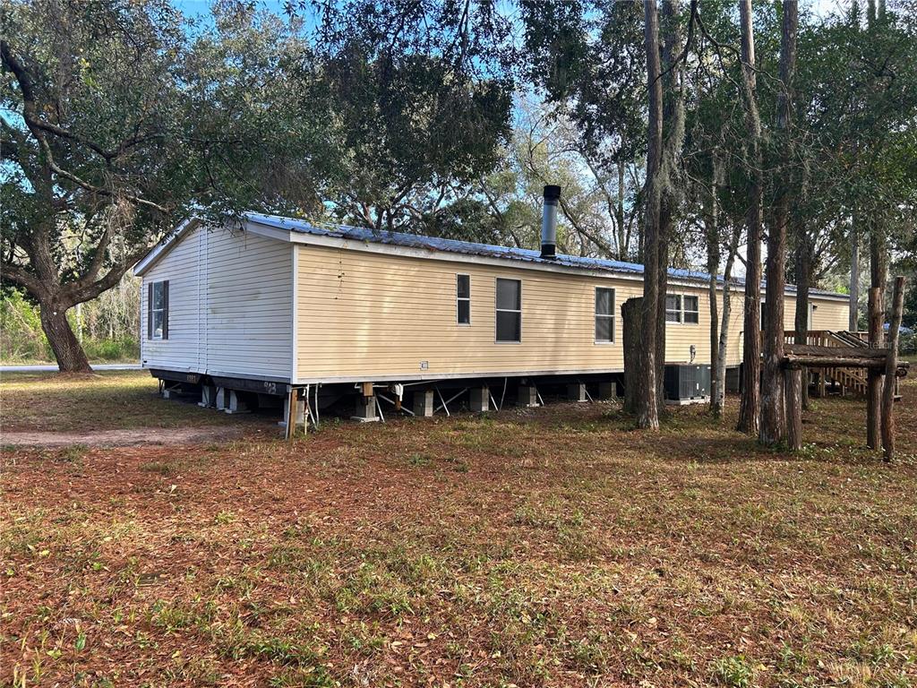 9867 Jerome Drive New Port Richey, FL 34654 - Photo 29 of 30 a house with trees in the background