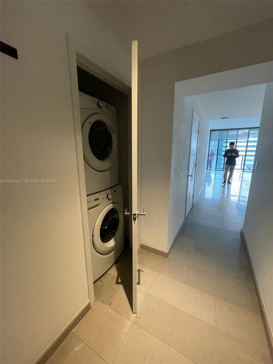 88 Southwest 7th Street, Unit 1608 Miami, FL 33130 - Photo 4 of 14 a view of a storage and utility room with washer and dryer