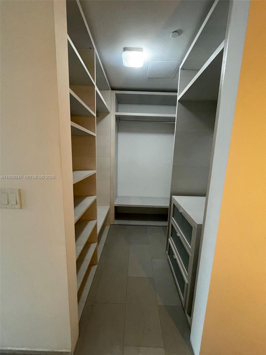 88 Southwest 7th Street, Unit 1608 Miami, FL 33130 - Photo 10 of 14 a view of walk in closet with empty racks