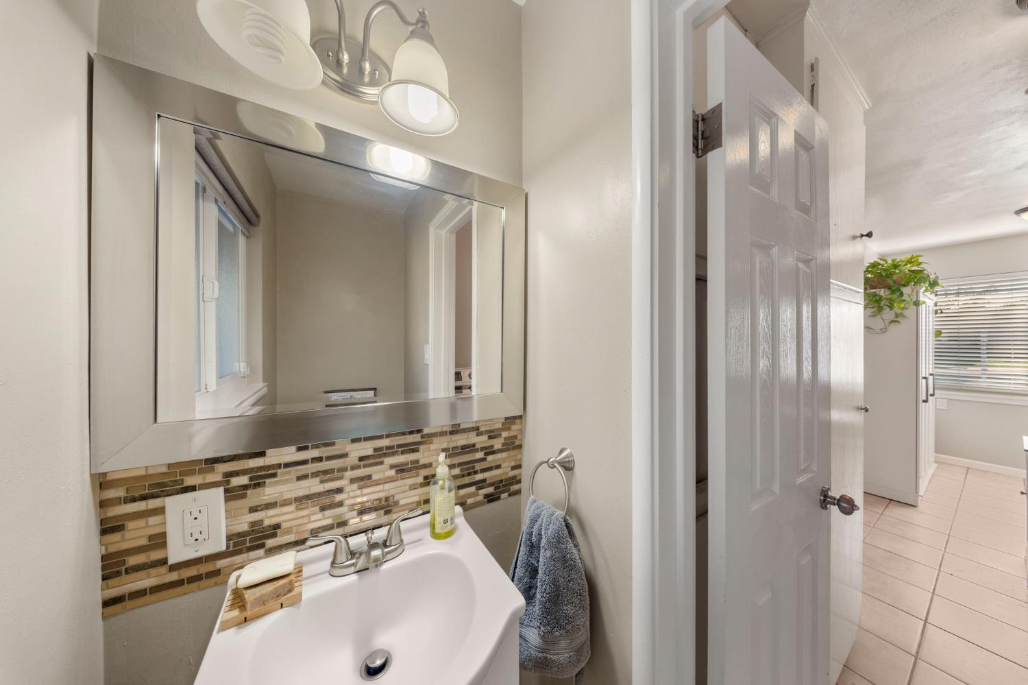1405 Fordham Avenue Modesto, CA 95350 - Photo 16 of 32 a bathroom with a sink and a mirror