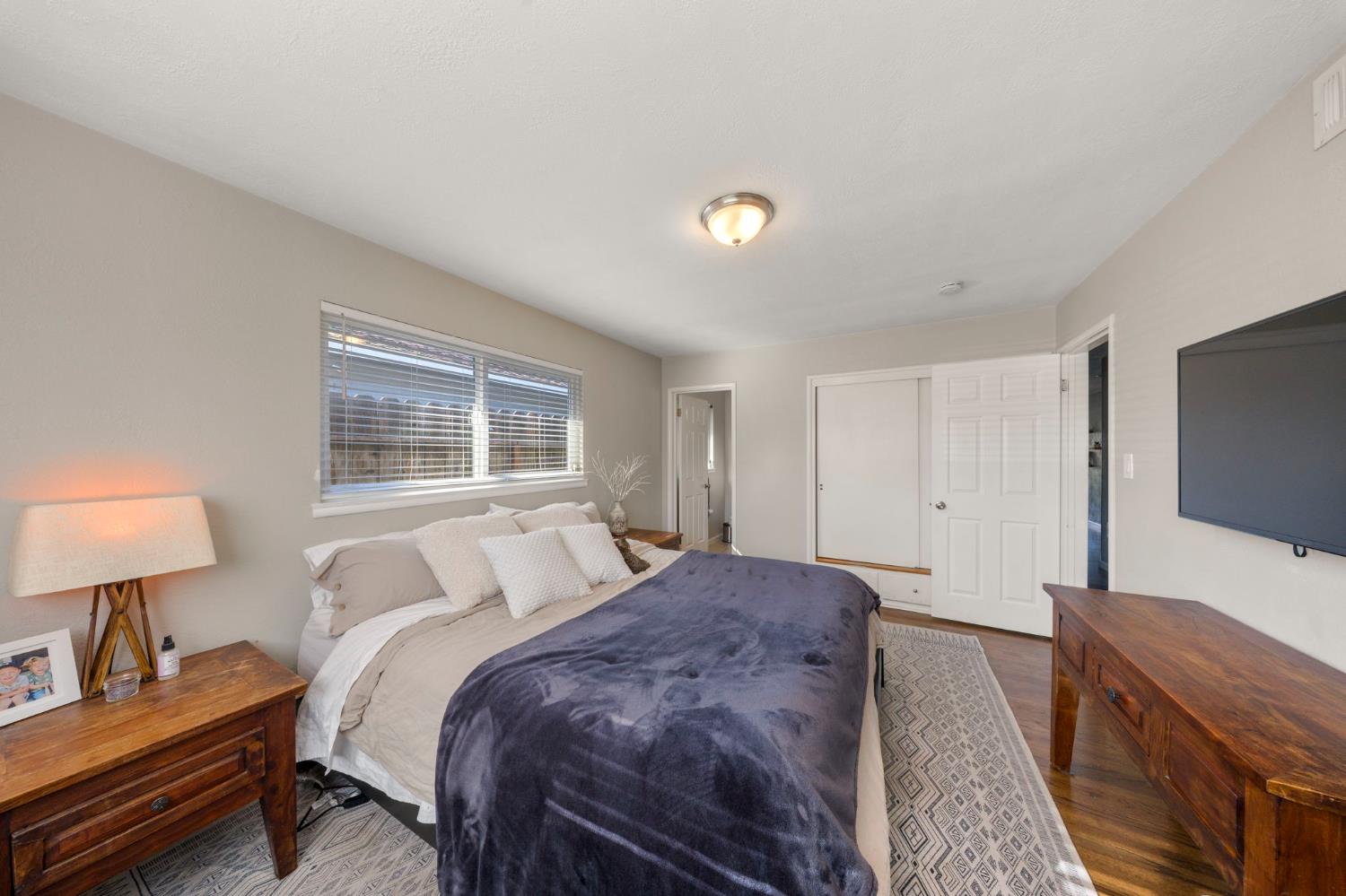 1405 Fordham Avenue Modesto, CA 95350 - Photo 25 of 32 a bedroom with a bed and a flat screen television