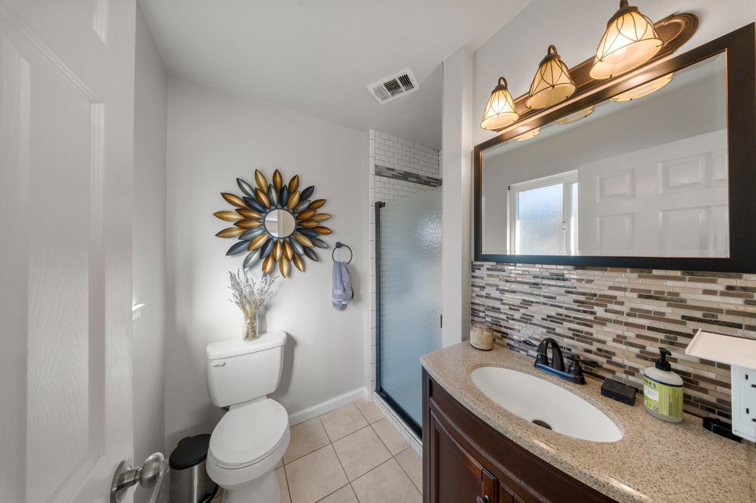1405 Fordham Avenue Modesto, CA 95350 - Photo 27 of 32 a bathroom with a granite countertop toilet sink and mirror