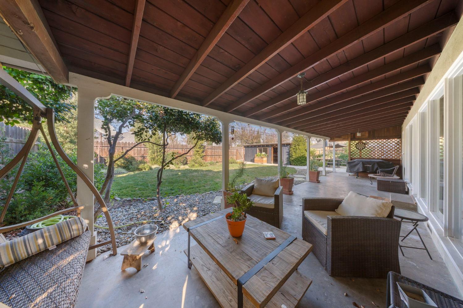 1405 Fordham Avenue Modesto, CA 95350 - Photo 29 of 32 a view of a patio with couches chairs and a table and chairs with wooden floor