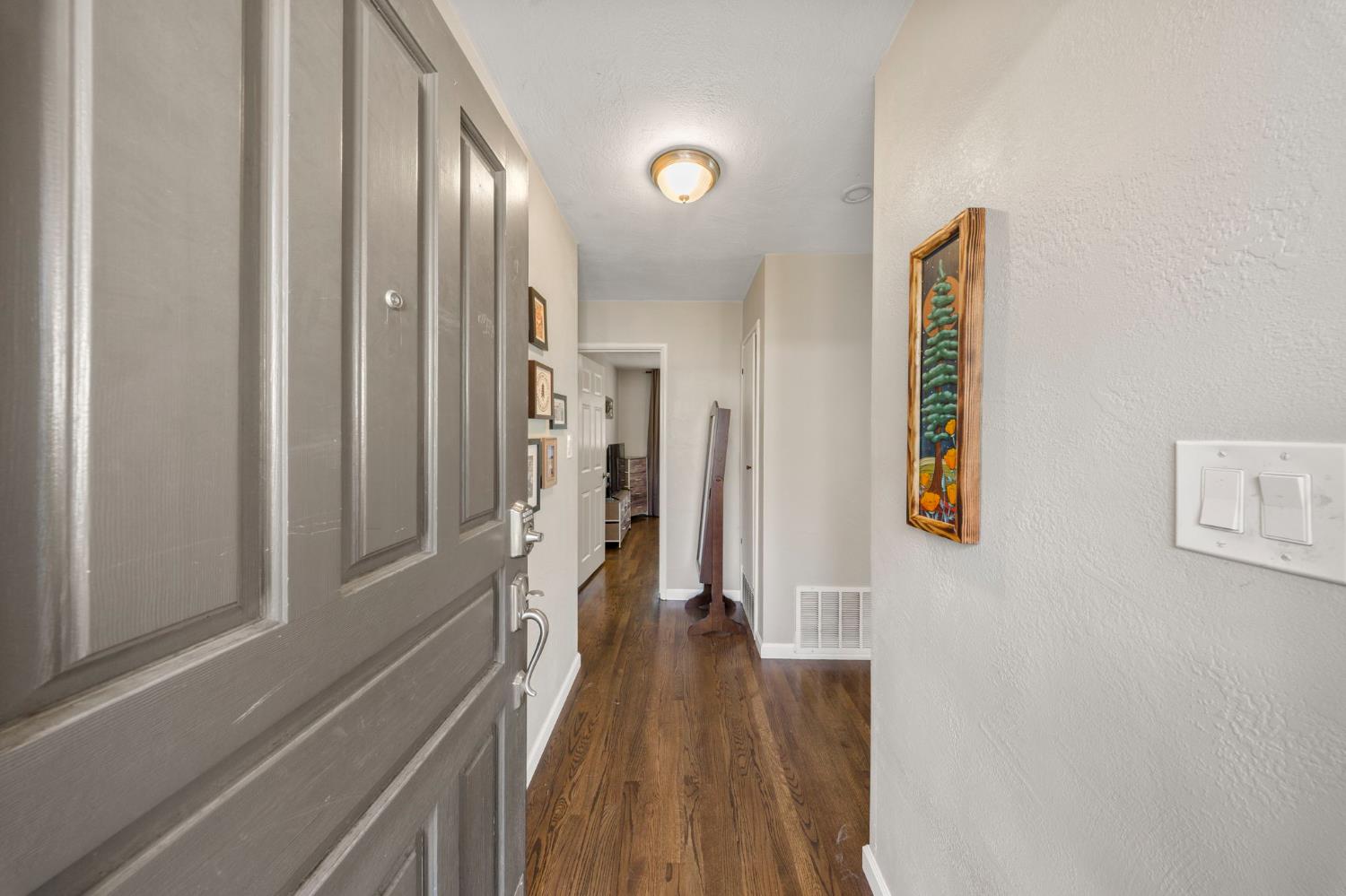 1405 Fordham Avenue Modesto, CA 95350 - Photo 6 of 32 a view of a hallway with wooden floor and staircase