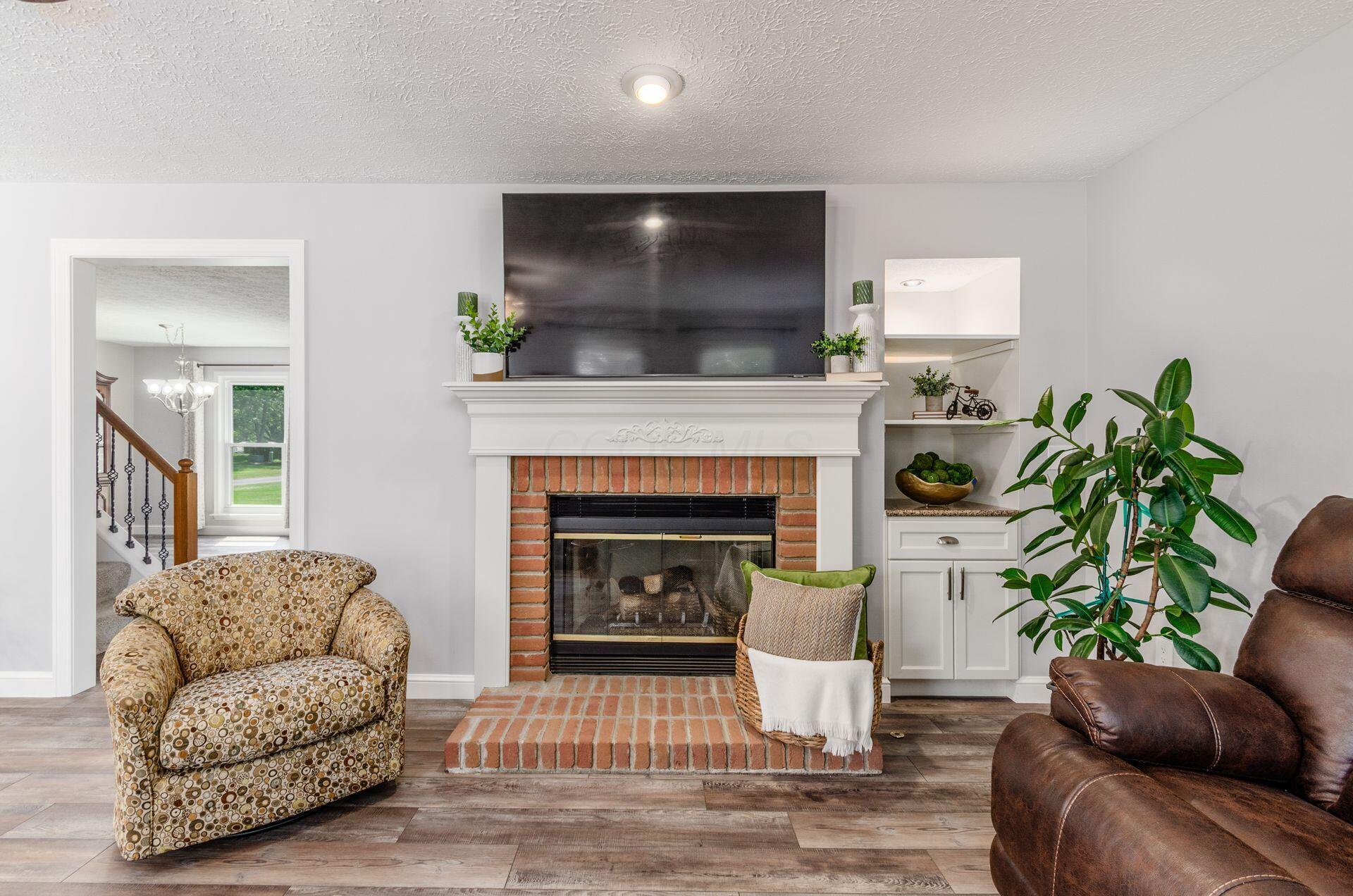 9471 Concord Road Powell, OH 43065 - Photo 9 of 40 GAS LOG FIREPLACE WITH BUILT-IN CABINET
