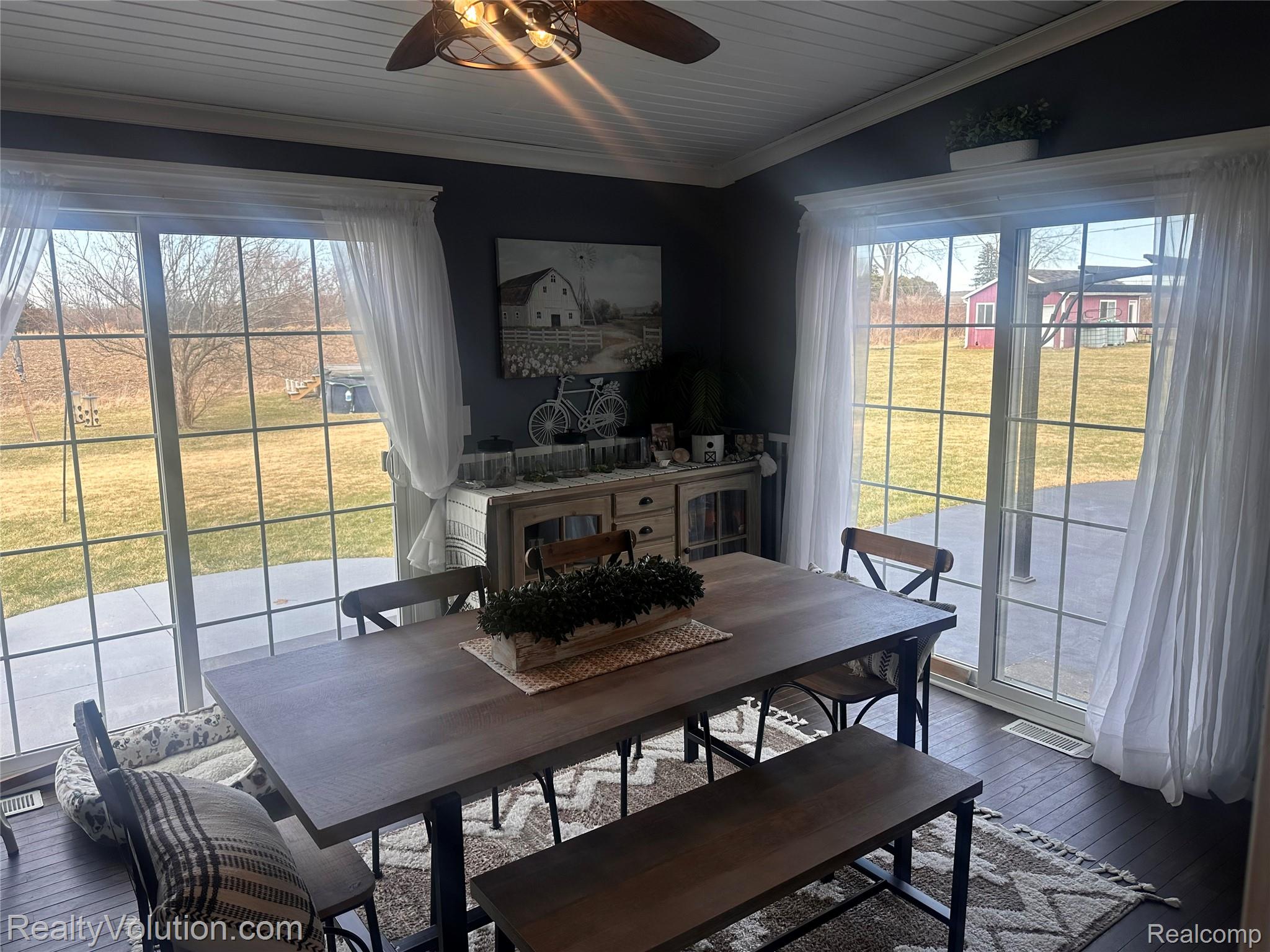 3034 West Oregon Road Lapeer, MI 48446 - Photo 16 of 29 Dining area with dark wood-style flooring, a ceiling fan, ornamental molding, and plenty of natural light