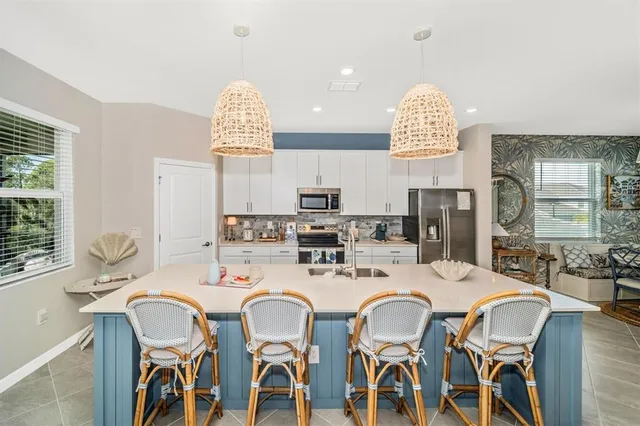 a large white bed sitting in a room next to a window