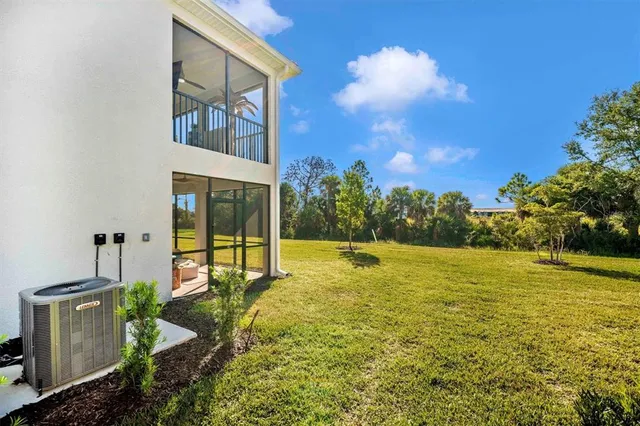 a view of a house with backyard porch and sitting area