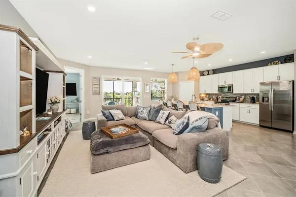 a living room with furniture a large window and chairs