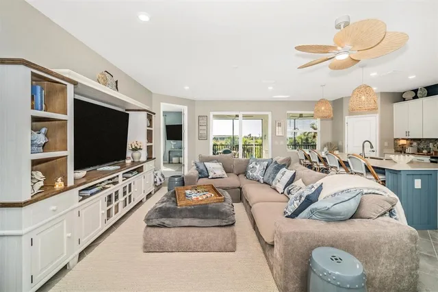 a dining room with furniture a chandelier and a kitchen view