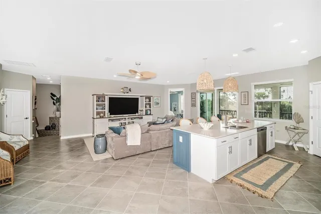a kitchen with stainless steel appliances a table chairs and a refrigerator