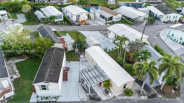 an aerial view of a house with a yard and potted plants
