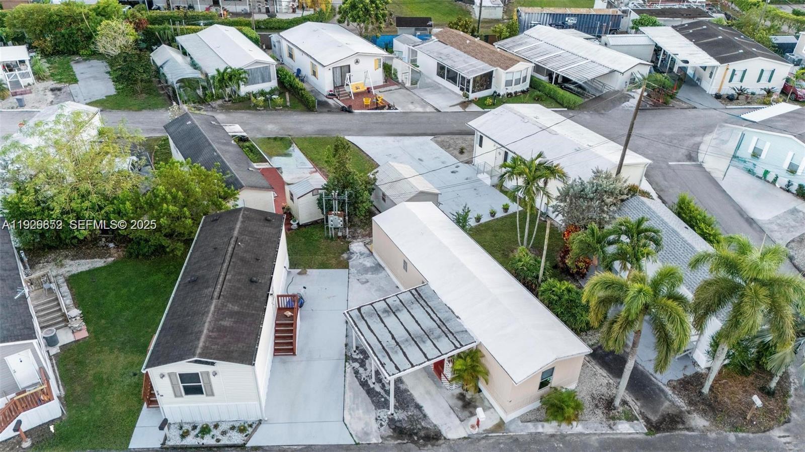 an aerial view of a house with a yard and potted plants