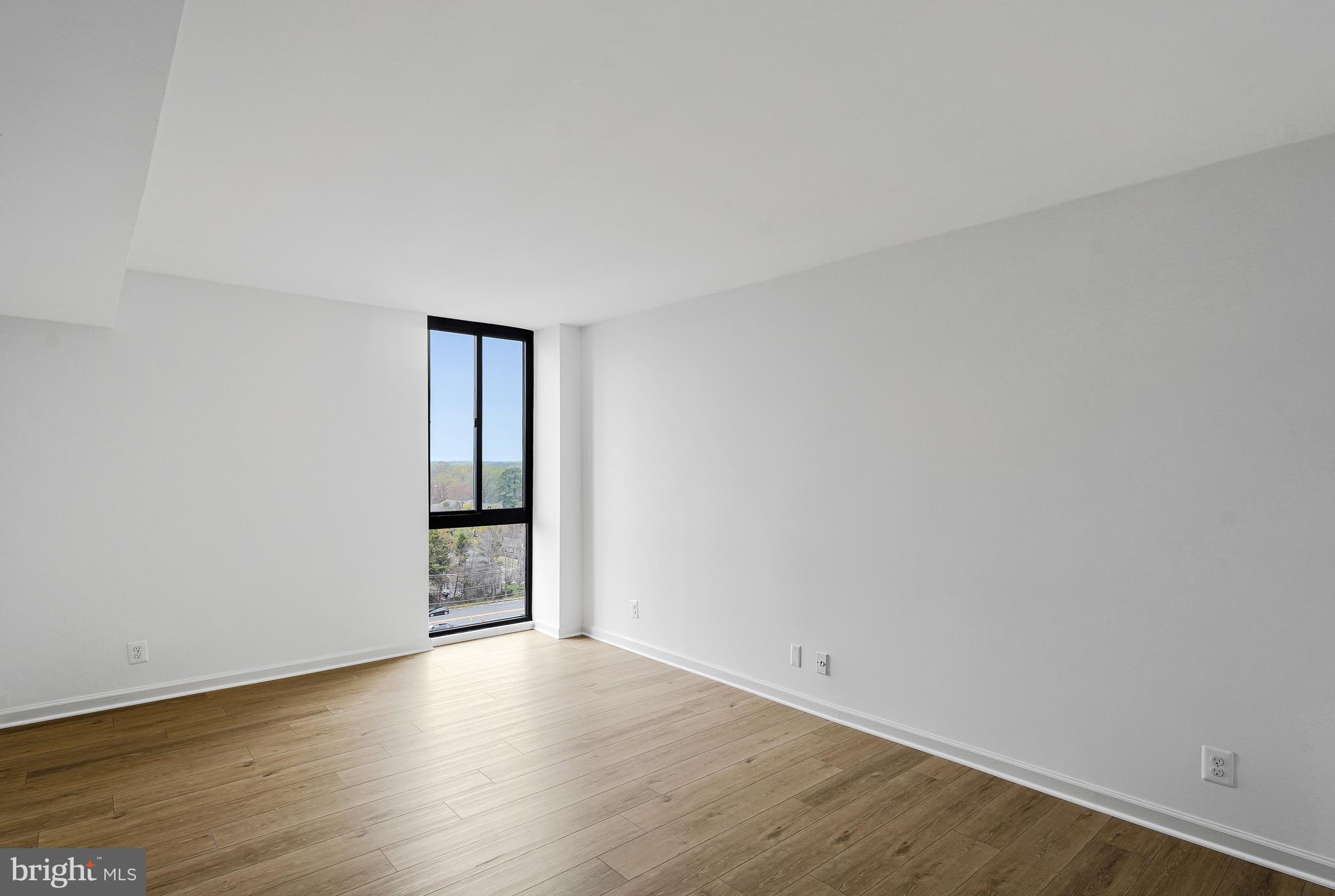 6800 Fleetwood Road, Unit 1013 McLean, VA 22101 - Photo 16 of 32 an empty room with wooden floor and natural light