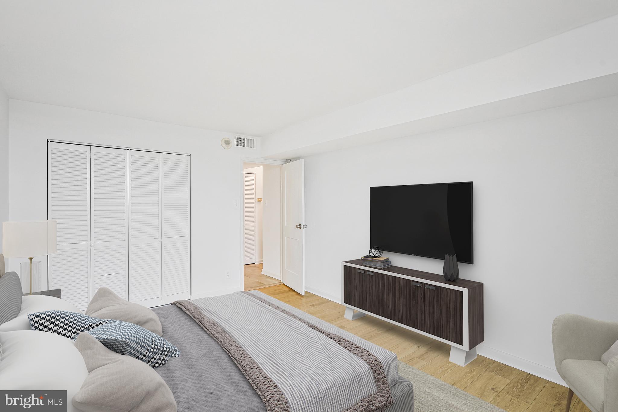 6800 Fleetwood Road, Unit 1013 McLean, VA 22101 - Photo 17 of 32 a bedroom with a bed and a flat screen tv