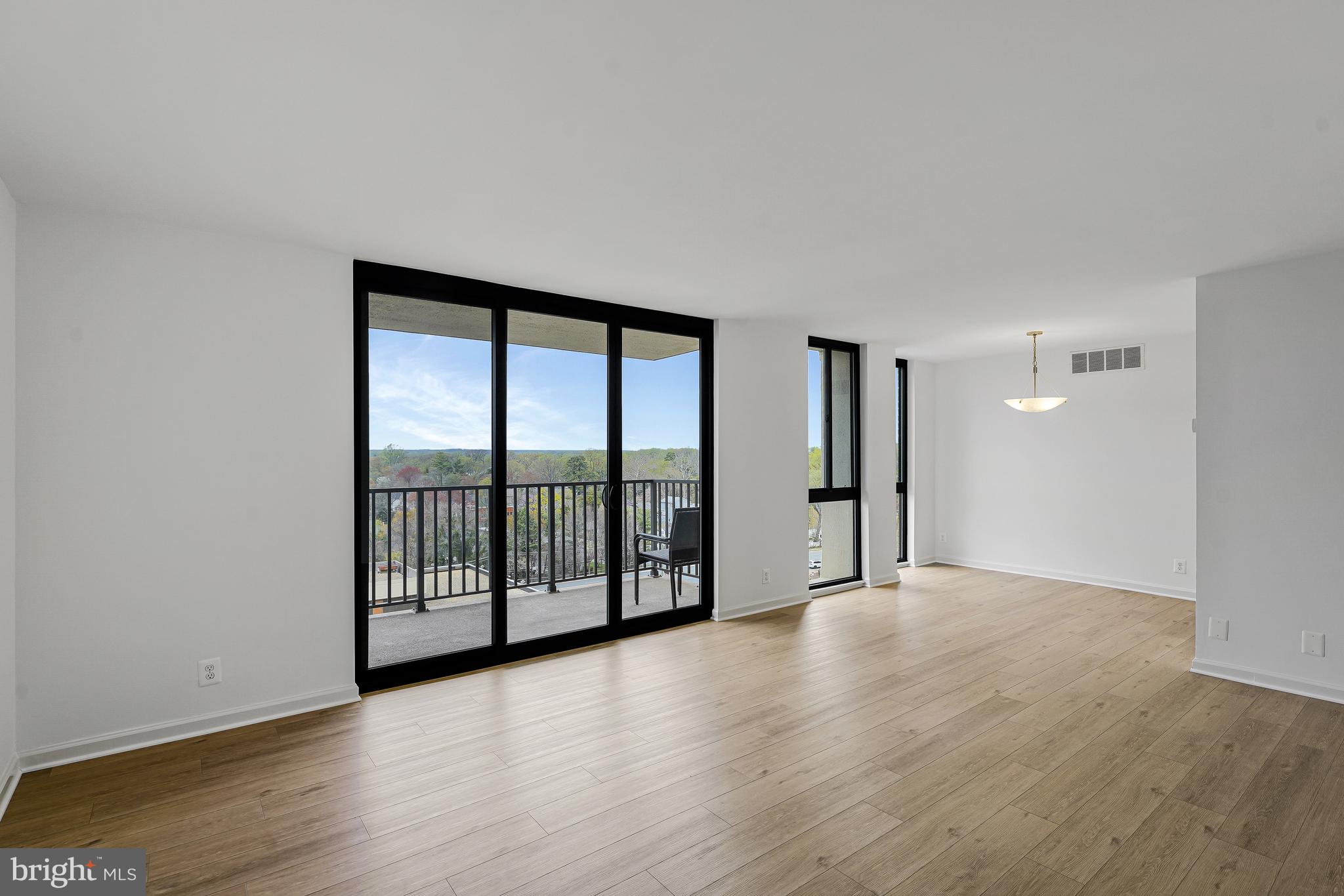 6800 Fleetwood Road, Unit 1013 McLean, VA 22101 - Photo 3 of 32 wooden floor in an empty room with windows