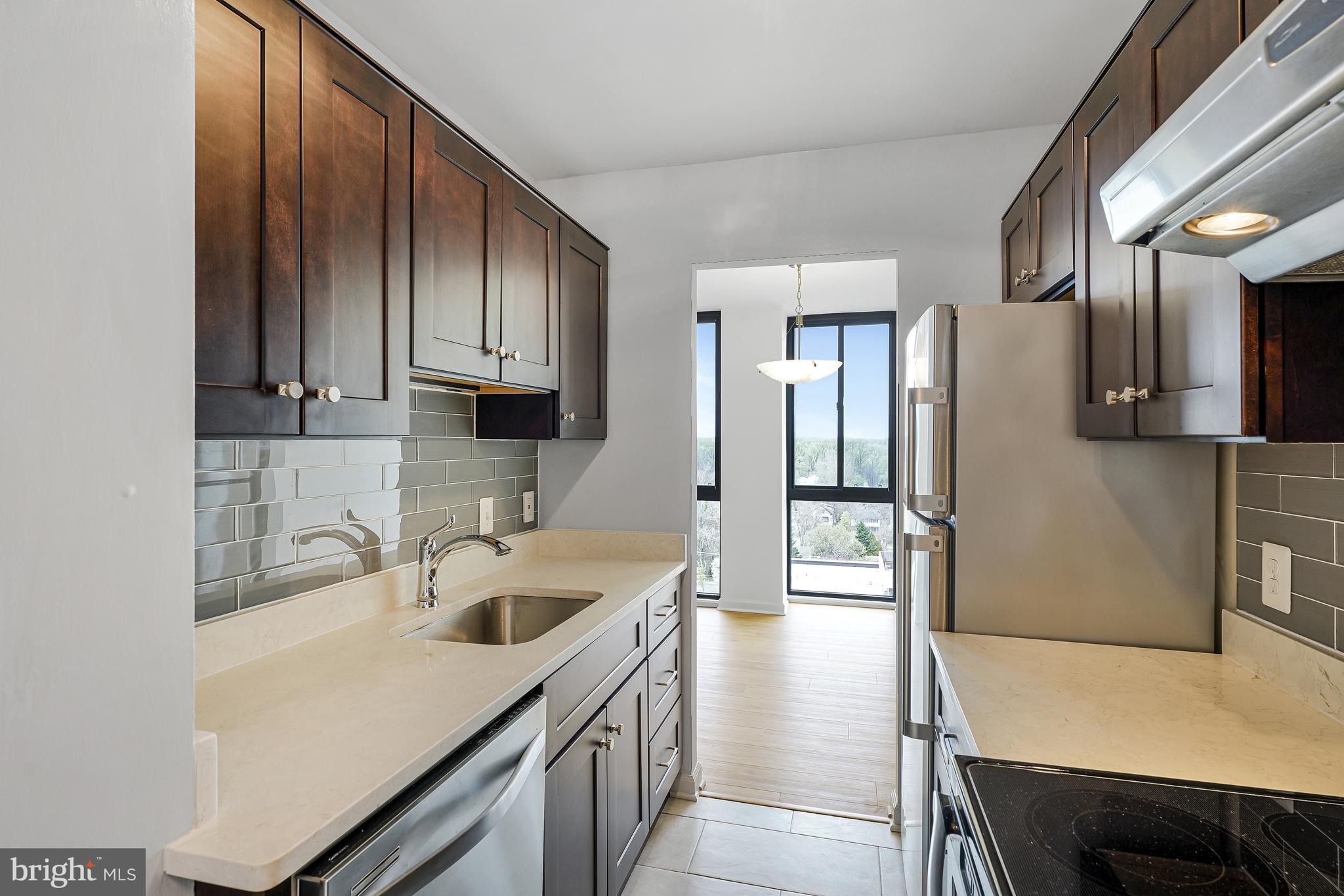 6800 Fleetwood Road, Unit 1013 McLean, VA 22101 - Photo 9 of 32 a kitchen with stainless steel appliances a sink a stove and refrigerator