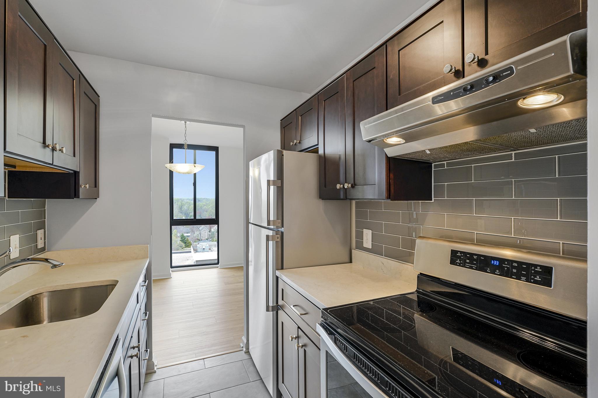 6800 Fleetwood Road, Unit 1013 McLean, VA 22101 - Photo 10 of 32 a kitchen with granite countertop a sink and stainless steel appliances