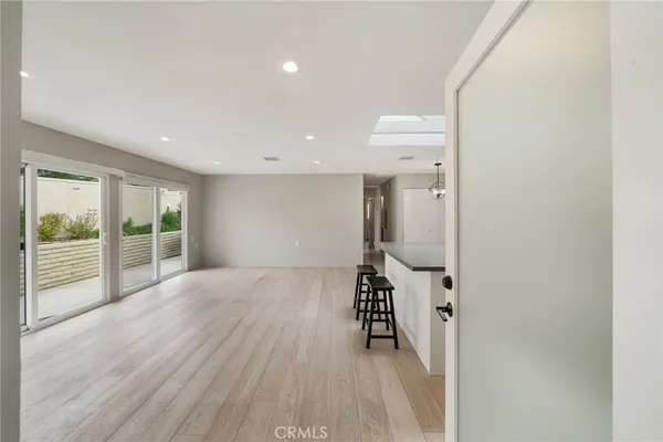 a kitchen with a sink stainless steel appliances and window