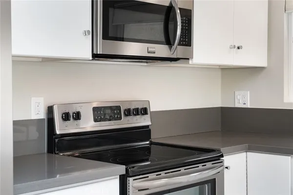 a kitchen with a stove a refrigerator and a sink