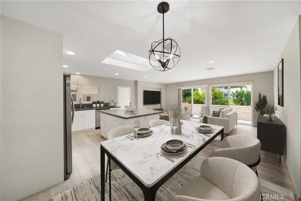 a view of a dining room with furniture wooden floor and chandelier