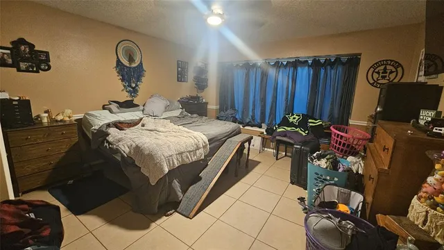 a bed room with a bed and a television