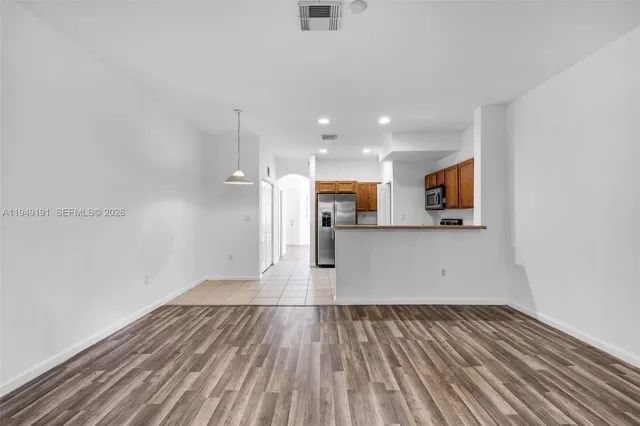 a view of a kitchen with microwave and stove top oven