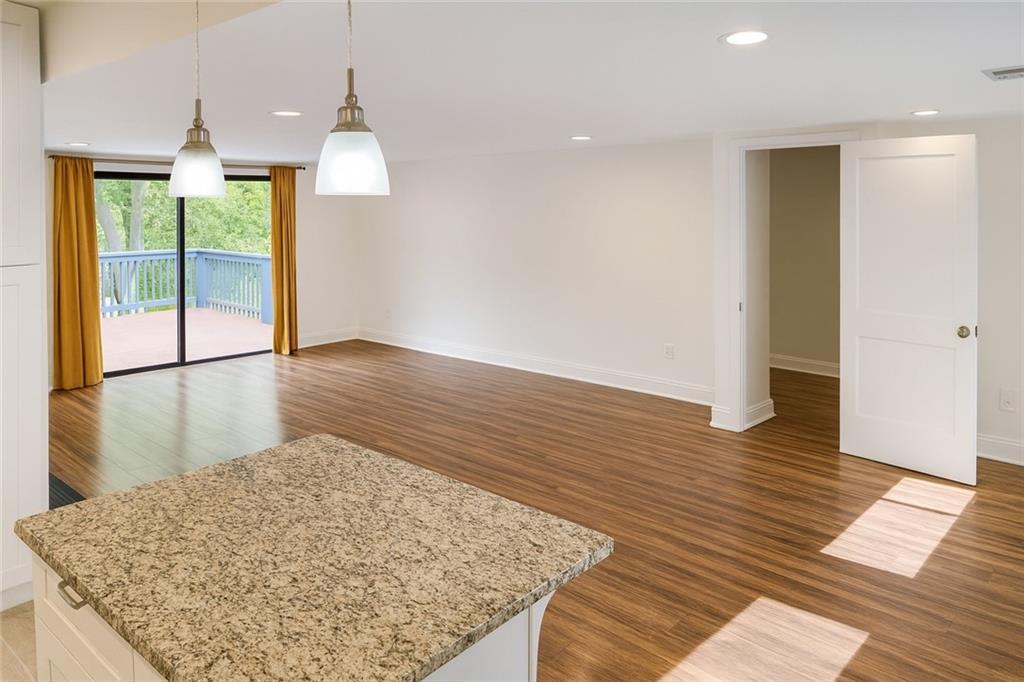 1512 South Hairston Road Stone Mountain, GA 30088 - Photo 4 of 11 an empty room with wooden floor and outdoor view