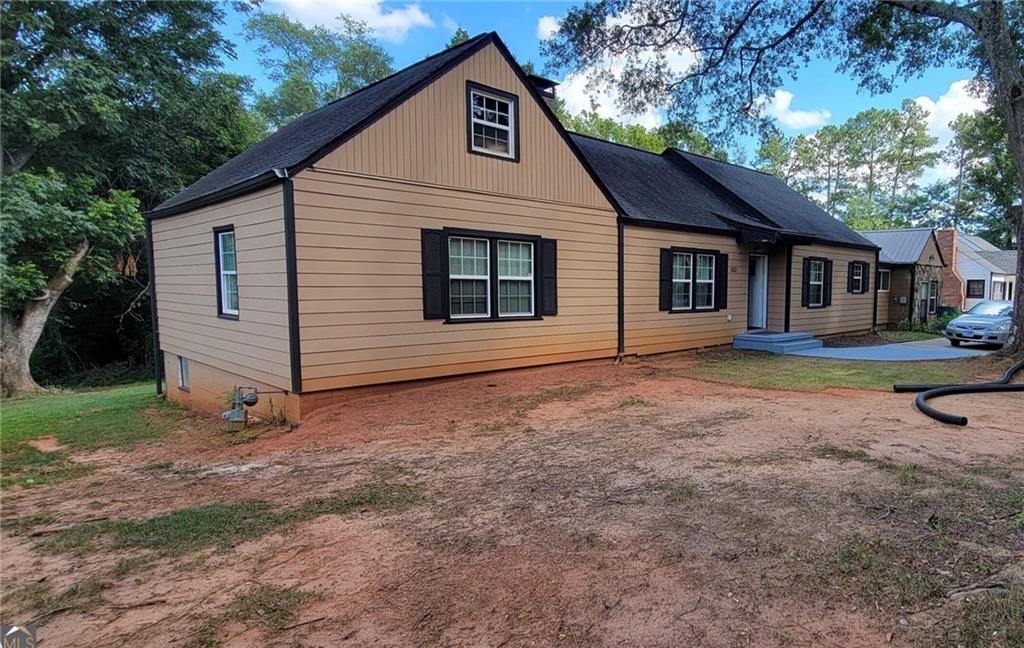 1512 South Hairston Road Stone Mountain, GA 30088 - Photo 7 of 11 a front view of a house with a yard and garage
