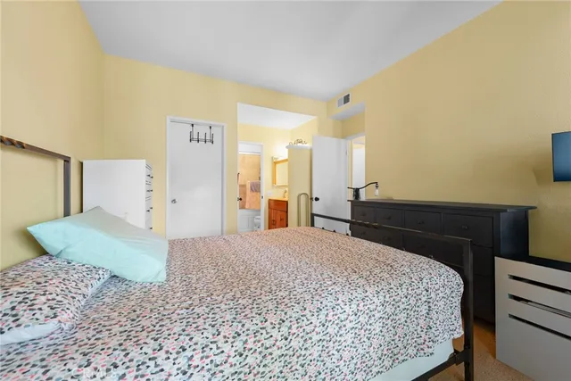 a bedroom with a bed and a dresser