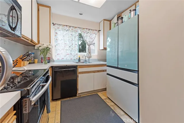 a kitchen with stainless steel appliances a stove and a refrigerator