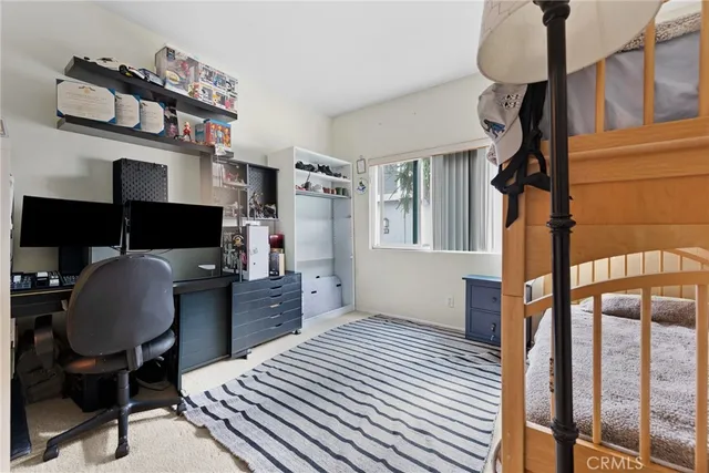 a bedroom with a workspace