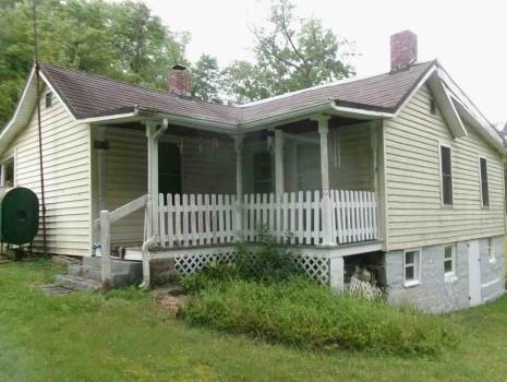 245 Higgins Road Hilliards, PA 16040 - Photo 2 of 13 a view of a house with a small yard and wooden fence