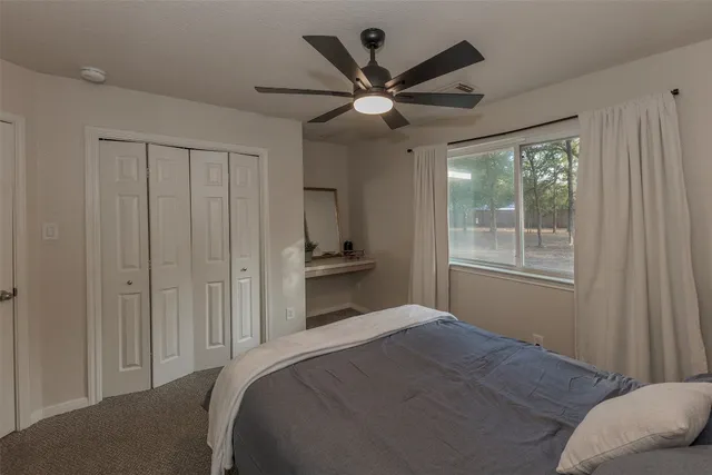 a bedroom with a large bed and a chandelier