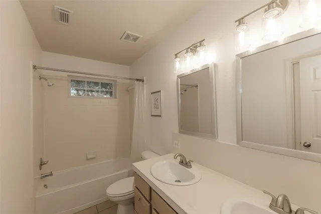a living room with furniture kitchen view and a large window