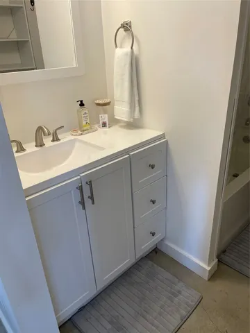 a bedroom with furniture and a flat screen tv