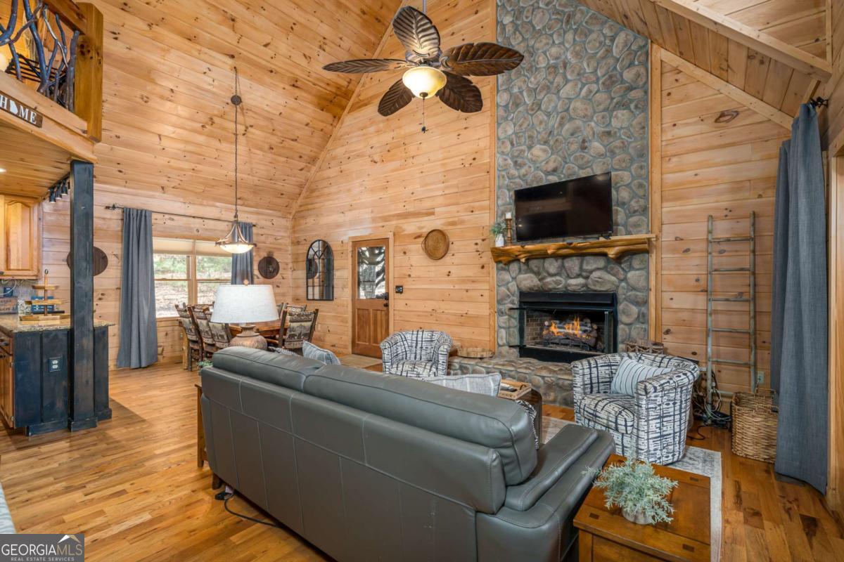 165 Christian Crossing, Unit 15 Morganton, GA 30560 - Photo 20 of 58 a living room with furniture a flat screen tv and a fireplace