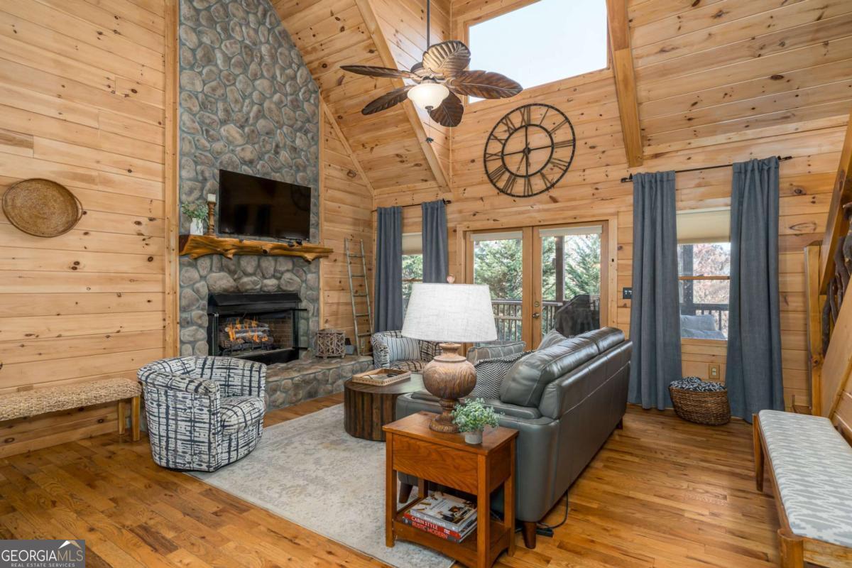 165 Christian Crossing, Unit 15 Morganton, GA 30560 - Photo 21 of 58 a living room with furniture a fireplace and a flat screen tv