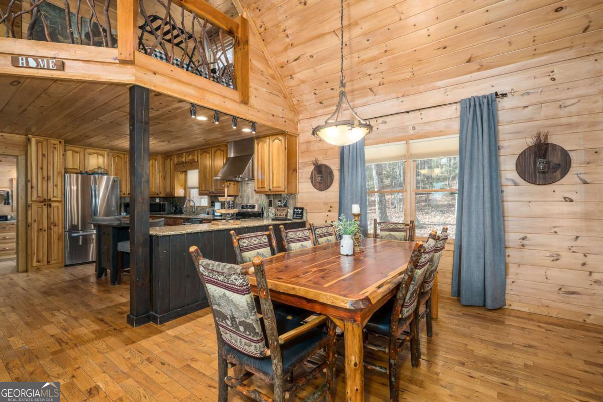 165 Christian Crossing, Unit 15 Morganton, GA 30560 - Photo 24 of 58 a view of a dining room with furniture window and wooden floor